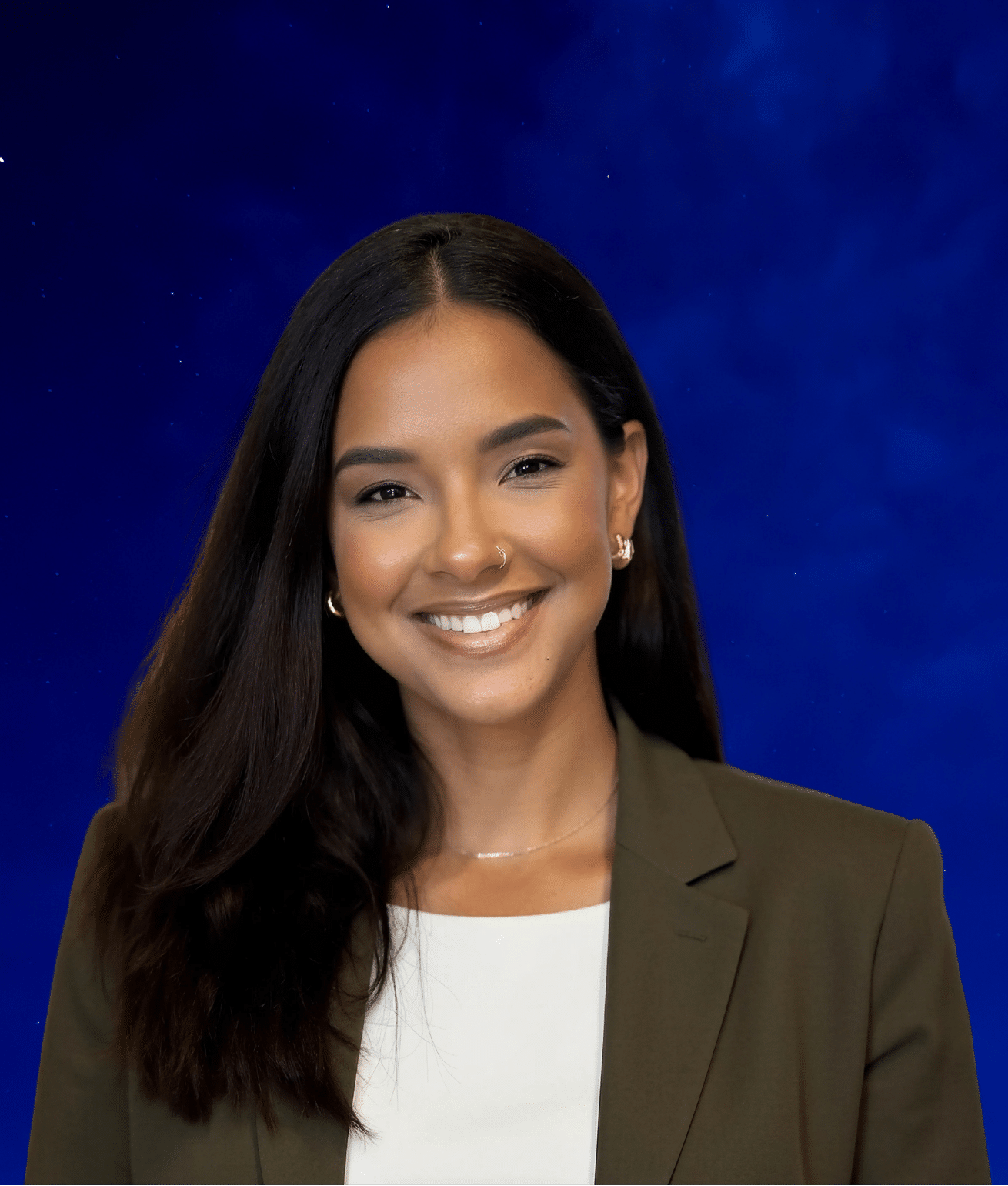 Smiling young woman with long dark hair, wearing a white top and olive blazer