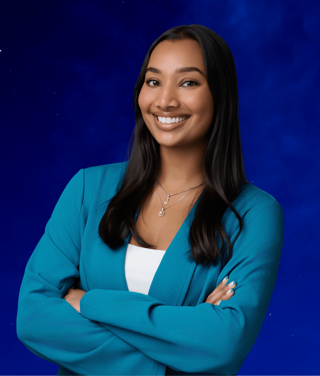 Smiling woman with long dark hair, wearing a teal blazer, white top, and crossed arms